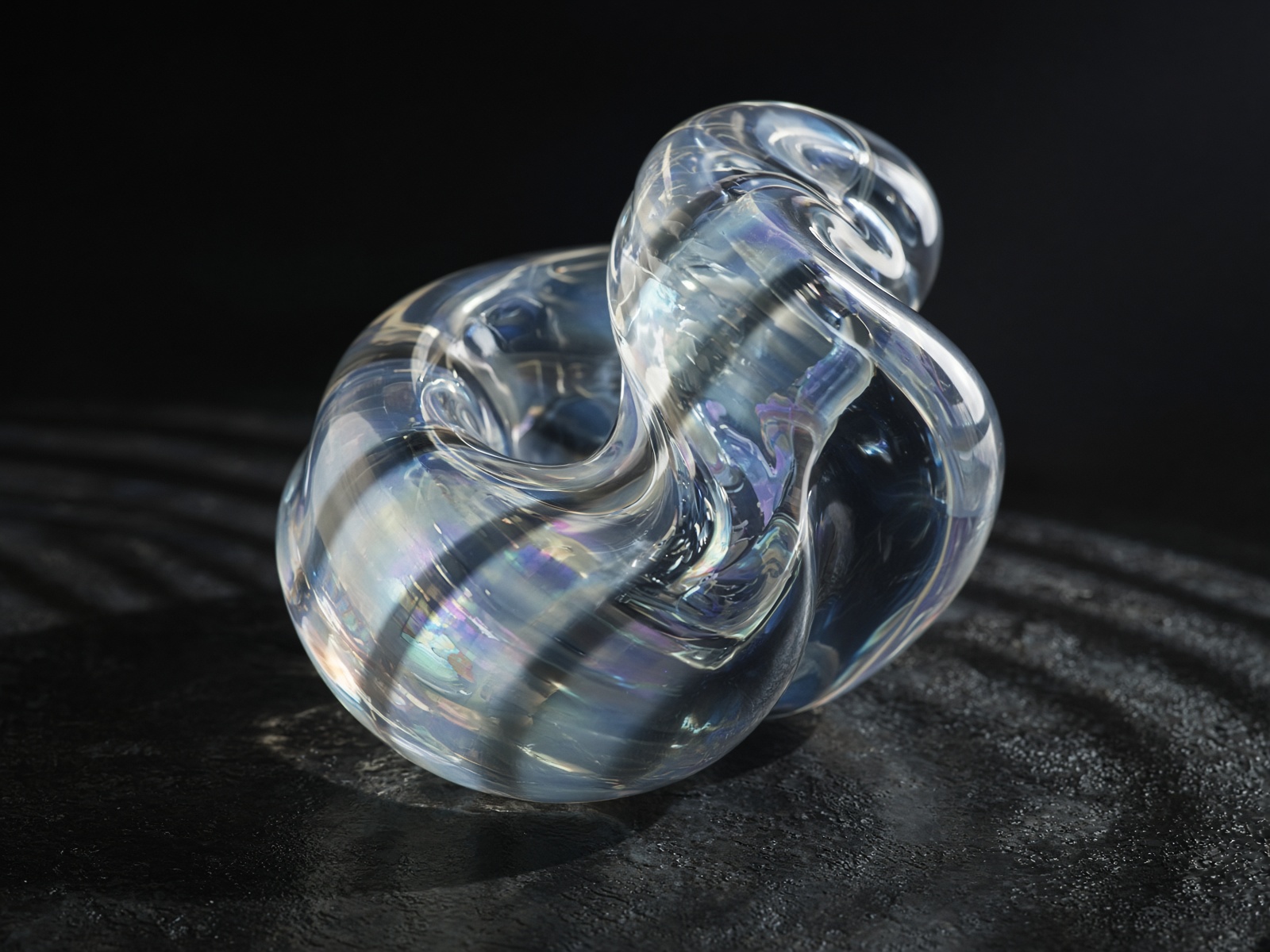 Iridescent glass with helix shadows across its surface